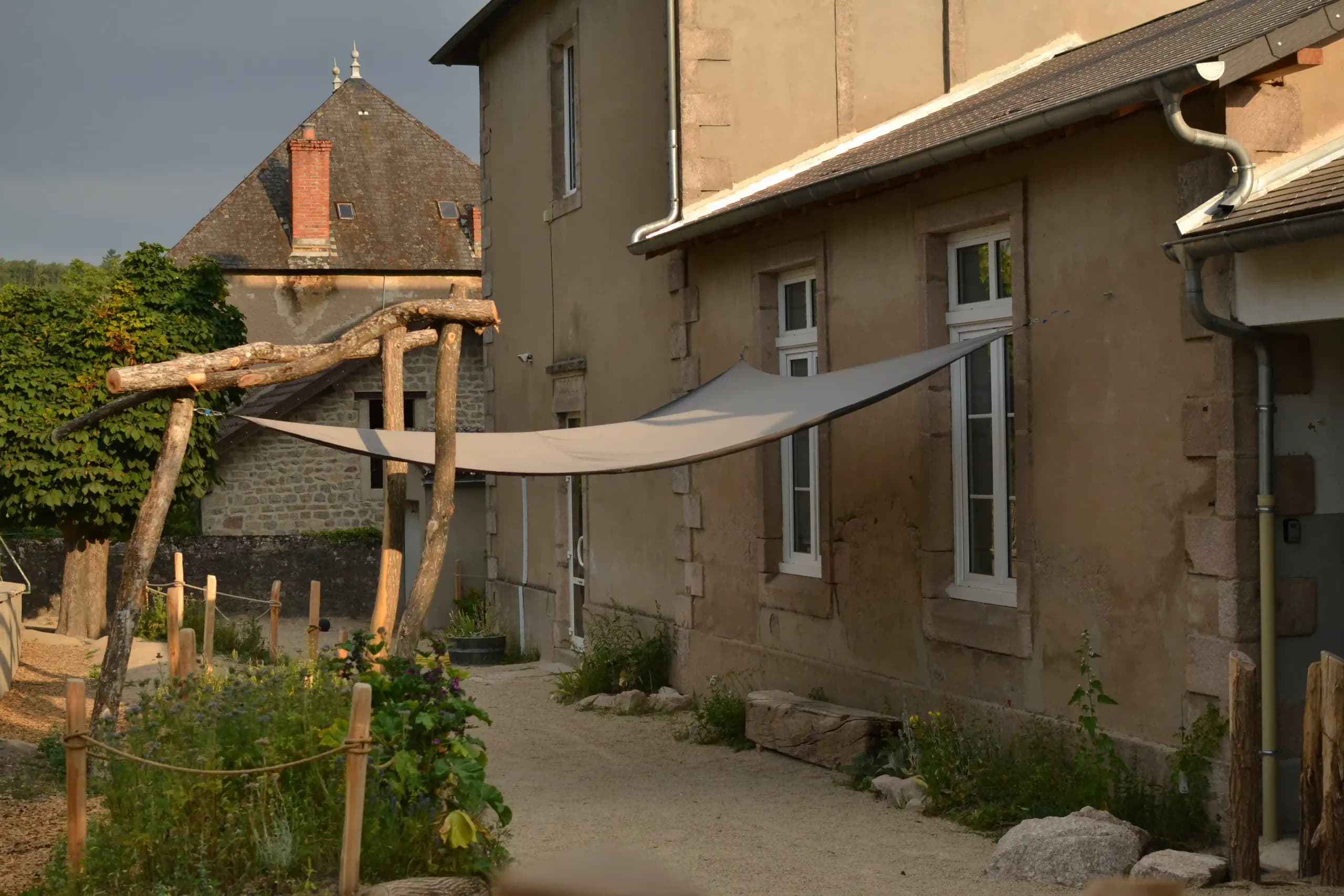 Pergola en bois et voile d'ombrage devant l'école